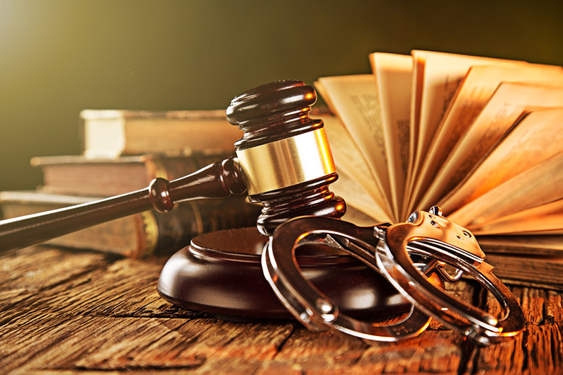 Wooden gavel and books on wooden table